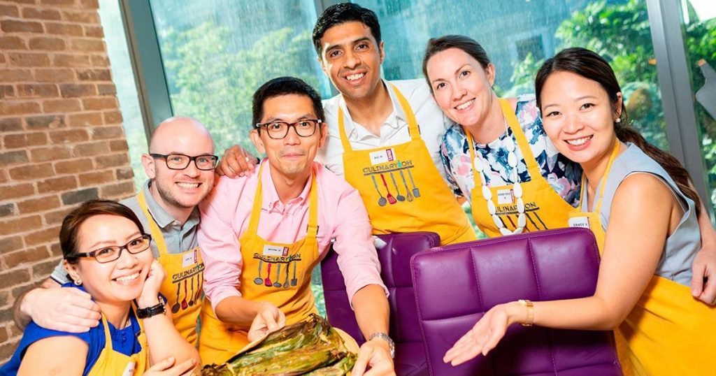 A group of people posing with food