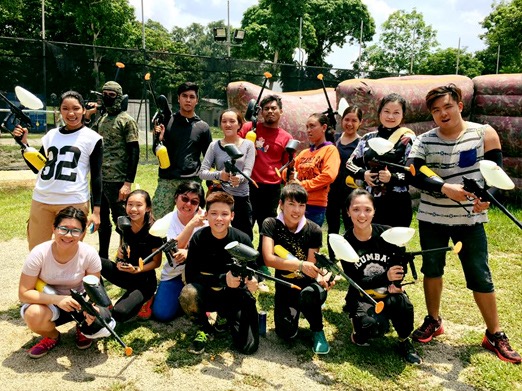 A group of people posing with their paintball guns