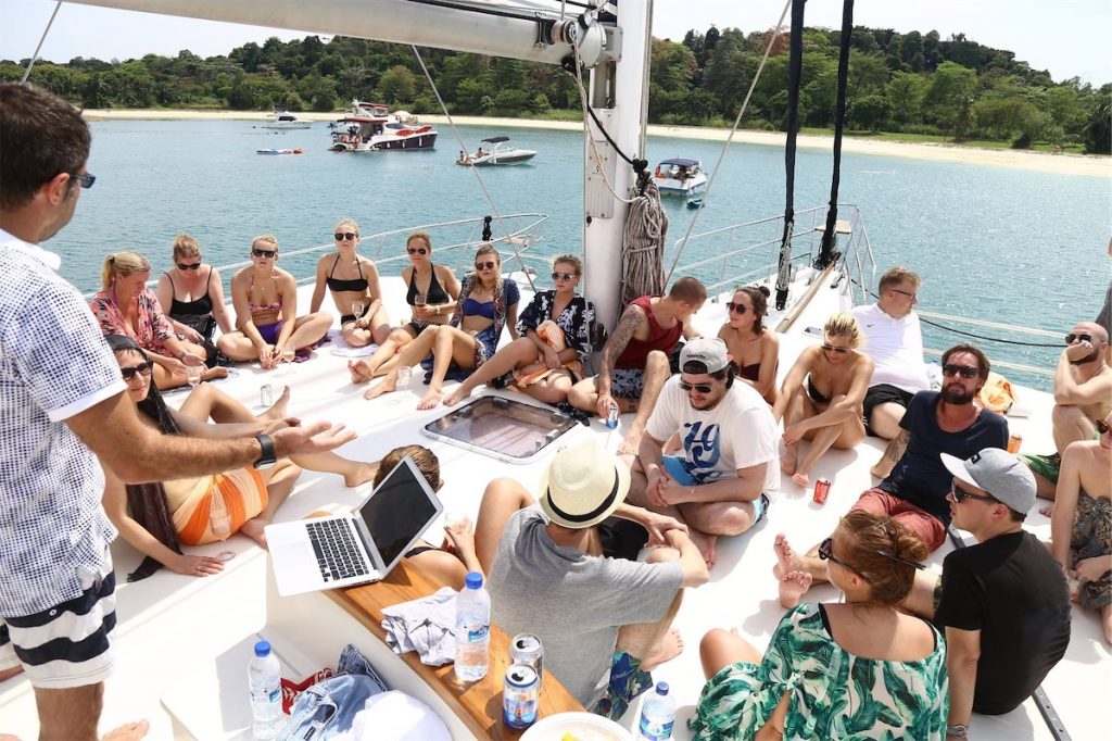 A group of people sitting on the deck of a yacht
